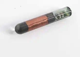 Chip transponder en cápsula de vidrio con su bobinado de cobre, la pieza que se programa en la llave